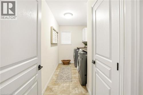 Dedicated laundry space featuring a window, overhead lighting, and neutral-toned wall paint - 129 Magnificent Way, Binbrook, ON - Indoor Photo Showing Other Room