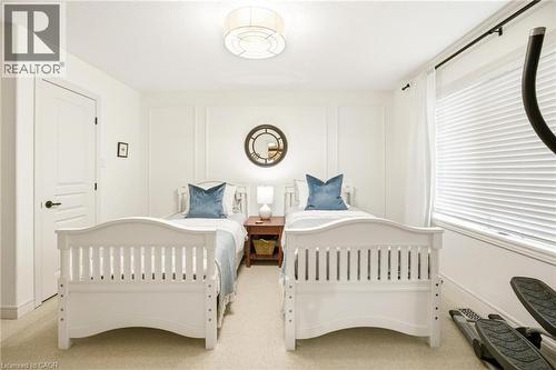 Carpeted interior room featuring bright white walls, panel molding, and a flush mount ceiling light fixture - 129 Magnificent Way, Binbrook, ON - Indoor Photo Showing Bedroom