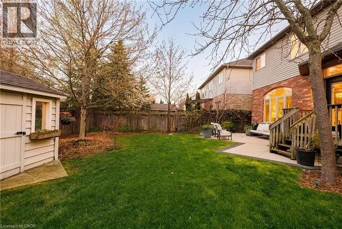 Expansive green lawn with mature trees and a privacy fence - 129 Magnificent Way, Binbrook, ON - Outdoor