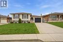 Ranch-style residence featuring a split-level design, light-colored brick facade, and stone accenting - 11 Marcella Crescent, Hamilton, ON  - Outdoor With Deck Patio Veranda With Facade 