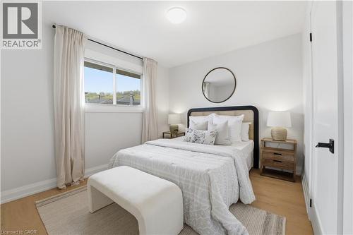 Room featuring wood-finish flooring and a large window - 11 Marcella Crescent, Hamilton, ON - Indoor Photo Showing Bedroom