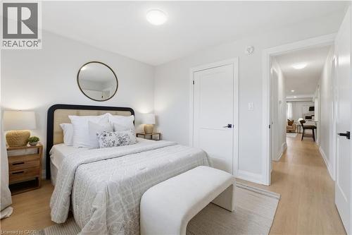 Hardwood-style flooring throughout, white walls, and a recessed ceiling light - 11 Marcella Crescent, Hamilton, ON - Indoor Photo Showing Bedroom