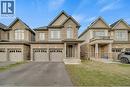 View of front of property with brick siding, driveway, a garage, and a front yard - 285 Broadacre Drive, Kitchener, ON  - Outdoor With Facade 