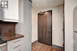 Wood-finish flooring extending from the entry into the kitchen area - 