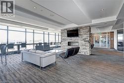 Contemporary interior lounge featuring a stone-clad fireplace with an integrated linear firebox - 