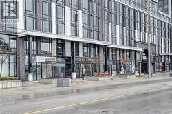 Modern commercial storefronts featuring expansive glass windows and sleek black framing - 
