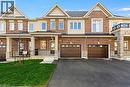 Brick and stone townhome exterior featuring multiple gables, covered porch entry, and an asphalt driveway - 205 Thames Way Unit# 31, Hamilton, ON  - Outdoor With Facade 
