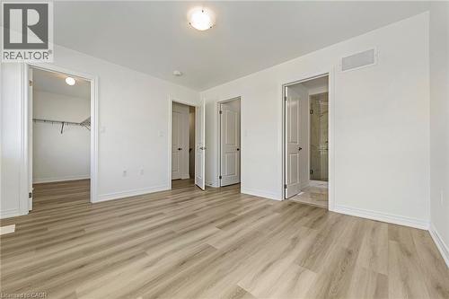 Spacious interior with light wood-finish flooring, white walls, and a recessed lighting fixture - 205 Thames Way Unit# 31, Hamilton, ON - Indoor Photo Showing Other Room