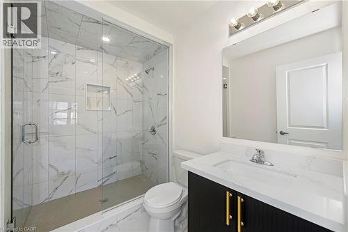 Glass-enclosed shower with white marble-look tile walls and an integrated niche - 205 Thames Way Unit# 31, Hamilton, ON - Indoor Photo Showing Bathroom