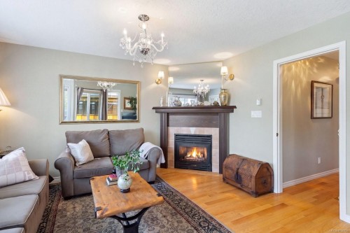1-9875 Third St, Sidney, BC - Indoor Photo Showing Living Room With Fireplace