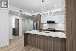 Kitchen. Photos may be of a similar home in the condo community. - 