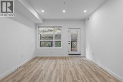 Kitchen, Dining & Living with patio access. Photos may be of a similar home in the condo community. - 