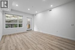 Kitchen, Dining & Living with patio access. Photos may be of a similar home in the condo community. - 