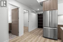Kitchen & Foyer. Photos may be of a similar home in the condo community. - 