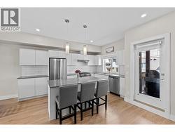 Spacious kitchen with quartz countertops and modern SS appliances throughout - 