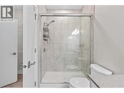 quartz counters and a walk in shower with custom tiled walls - 