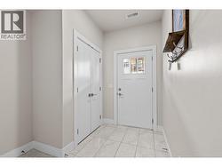 Tiled foyer with access to the garage and stairs to main floor, - 