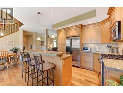 Kitchen with granite counters, eating bar, stainless steel appliances (gas stove) - 