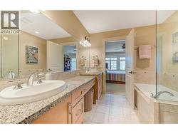 Primary ensuite - 5 pc. Dual vanities, granite counters, tile/glass shower, tub and heated floors - 