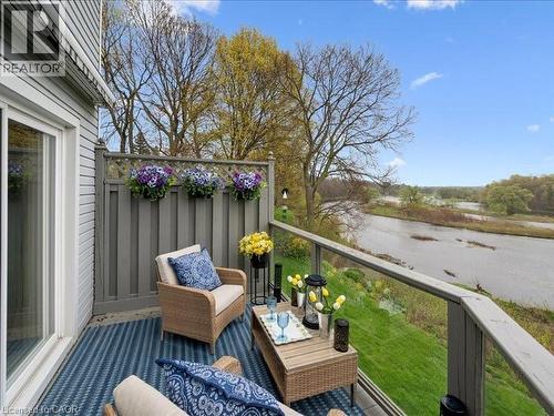Amazing views everyday! Exterior balcony featuring a clear glass railing, a privacy lattice panel, and a sliding glass door - 245 Bishop Street S Unit# 4, Cambridge, ON - Outdoor With Deck Patio Veranda