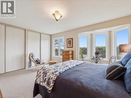 Amazing morning sunrise views over The Grand River from your Primary Bedroom - 245 Bishop Street S Unit# 4, Cambridge, ON - Indoor Photo Showing Bedroom
