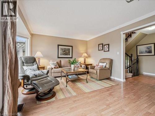 Living area featuring light wood-finish flooring, neutral wall paint, and white crown molding - 245 Bishop Street S Unit# 4, Cambridge, ON - Indoor Photo Showing Living Room
