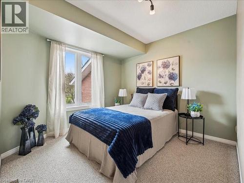 Carpeted room featuring a double window, light green walls, a white ceiling, and white baseboards - 245 Bishop Street S Unit# 4, Cambridge, ON - Indoor Photo Showing Bedroom