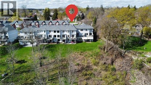 Aerial perspective showcasing a multi-unit residential property with a light gray exterior - 245 Bishop Street S Unit# 4, Cambridge, ON - Outdoor