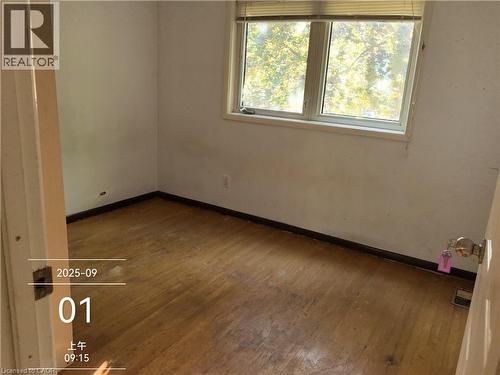 Room featuring wood-finish flooring, white walls, and a multi-pane window - 134 Greenbrier Drive, Waterloo, ON - Indoor Photo Showing Other Room