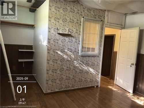 Interior space featuring wood-finish flooring, a window with blinds, and paneled walls - 134 Greenbrier Drive, Waterloo, ON - Indoor Photo Showing Other Room