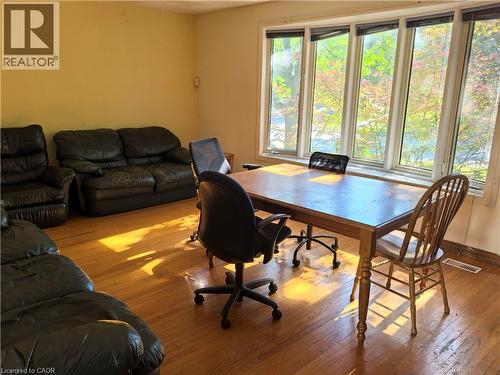 Spacious room featuring a multi-pane window, wood-finish flooring, and light-toned walls - 134 Greenbrier Drive, Waterloo, ON - Indoor