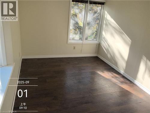 Room featuring wood-finish flooring, neutral wall paint, and white baseboards - 134 Greenbrier Drive, Waterloo, ON - Indoor Photo Showing Other Room