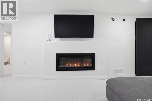 709 Inver Crescent E, Regina, SK - Indoor Photo Showing Living Room With Fireplace