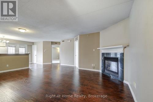 212 - 4005 Kilmer Drive, Burlington (Tansley), ON - Indoor Photo Showing Living Room With Fireplace