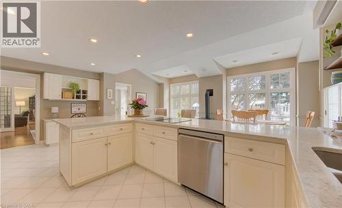Spacious kitchen featuring an extended center island with integrated cooktop and stainless steel dishwasher - 514 Colonial Drive, Waterloo, ON - Indoor Photo Showing Kitchen