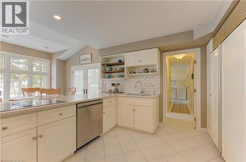 Kitchen featuring white cabinetry, a built-in cooktop, stainless steel dishwasher, and a light-toned countertop - 514 Colonial Drive, Waterloo, ON - Indoor Photo Showing Kitchen With Double Sink