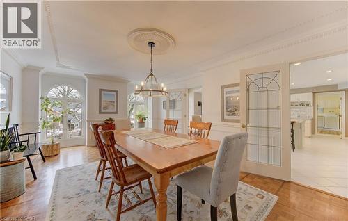 Formal dining area with parquet wood flooring and decorative ceiling molding - 514 Colonial Drive, Waterloo, ON - Indoor Photo Showing Dining Room