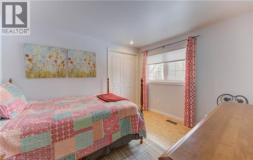 Bright interior space with light-colored walls and wood-finish flooring - 514 Colonial Drive, Waterloo, ON - Indoor Photo Showing Bedroom