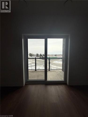 Empty room featuring dark wood finished floors - 1000 Lackner Place Unit# 401, Kitchener, ON - Indoor Photo Showing Other Room