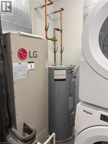 Utilities with stacked washer and clothes dryer and electric water heater - 1000 Lackner Place Unit# 401, Kitchener, ON - Indoor Photo Showing Laundry Room