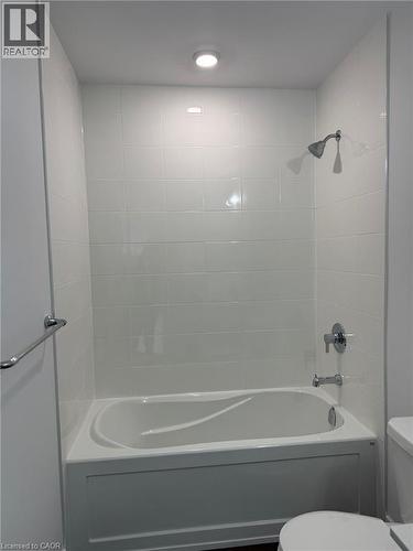 Bathroom featuring toilet and washtub / shower combination - 1000 Lackner Place Unit# 401, Kitchener, ON - Indoor Photo Showing Bathroom
