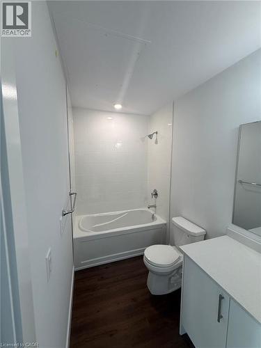 Full bath featuring wood finished floors, toilet, shower / bathing tub combination, and vanity - 1000 Lackner Place Unit# 401, Kitchener, ON - Indoor Photo Showing Bathroom