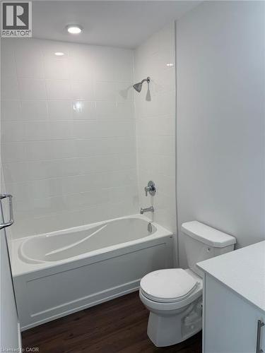 Full bath featuring toilet, wood finished floors, vanity, and shower / bath combination - 1000 Lackner Place Unit# 401, Kitchener, ON - Indoor Photo Showing Bathroom