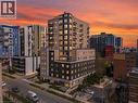 Modern high-rise building featuring a multi-story facade, extensive window lines, individual balconies, and street-level pedestrian access - 246 Lester Street Unit# Ph-03, Waterloo, ON  - Outdoor With Balcony With Facade 