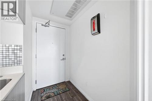 Entryway featuring wood-finish flooring, white walls, and a door with chrome hardware - 246 Lester Street Unit# Ph-03, Waterloo, ON - Indoor Photo Showing Other Room