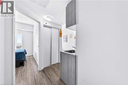 Compact kitchenette featuring a stainless steel sink, wood-finish lower cabinetry, and a matching overhead cabinet - 246 Lester Street Unit# Ph-03, Waterloo, ON - Indoor Photo Showing Other Room