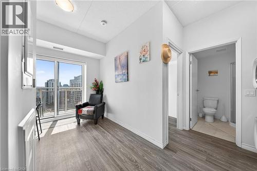 Living area featuring wood-finish flooring and a glass sliding door opening to a balcony - 246 Lester Street Unit# Ph-03, Waterloo, ON - Indoor