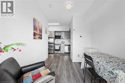 Open-concept living space with wood-finish flooring extending into the kitchen - 