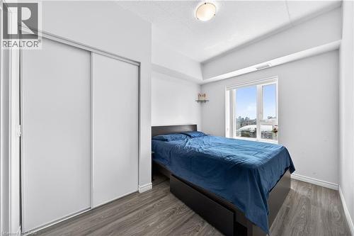 Room featuring light gray walls, wood-finish flooring, and white baseboards - 246 Lester Street Unit# Ph-03, Waterloo, ON - Indoor Photo Showing Bedroom