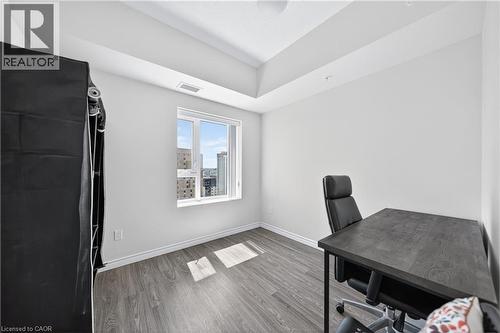 Bright room featuring wood-finish flooring, white baseboards, a large window, and high ceilings with tray detailing - 246 Lester Street Unit# Ph-03, Waterloo, ON - Indoor